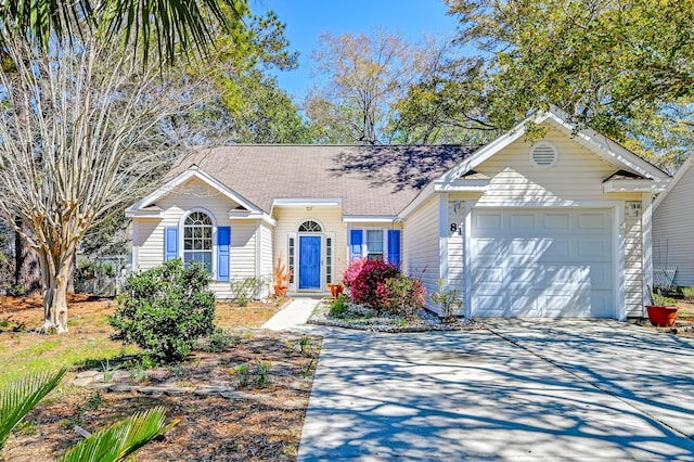 ranch-style home featuring an attached garage, a shingled roof, and concrete driveway