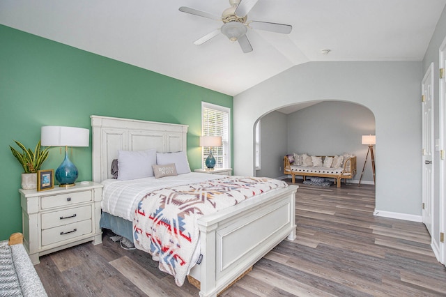 bedroom with ceiling fan, vaulted ceiling, and hardwood / wood-style flooring