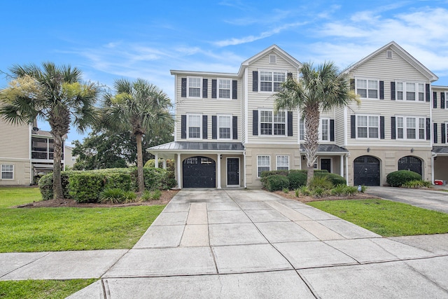 view of front of home with a front lawn and a garage