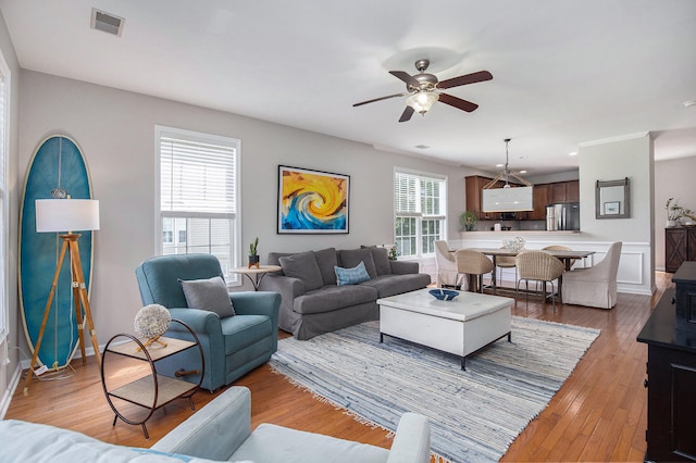 living room featuring ceiling fan and hardwood / wood-style flooring