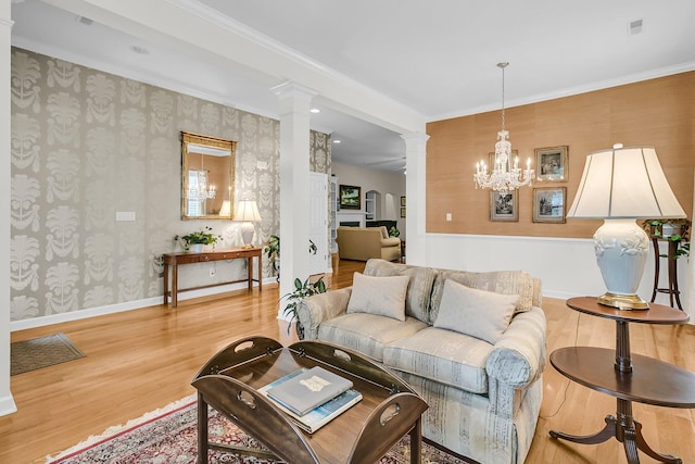 1809 Two Cedar Way, Mount Pleasant, SC 29466 - living room with decorative columns, wallpapered walls, wood finished floors, ornamental molding, and a chandelier
