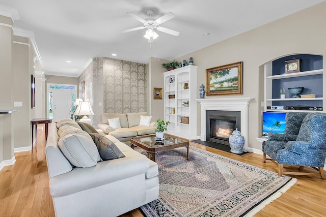 1809 Two Cedar Way, Mount Pleasant, SC 29466 - living area with built in features, wood finished floors, a glass covered fireplace, and ornamental molding