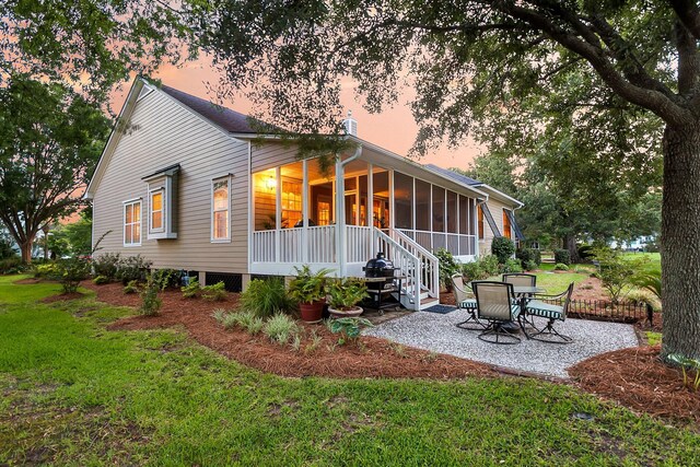 1809 Two Cedar Way, Mount Pleasant, SC 29466 - back of property with a sunroom, a patio area, and a lawn