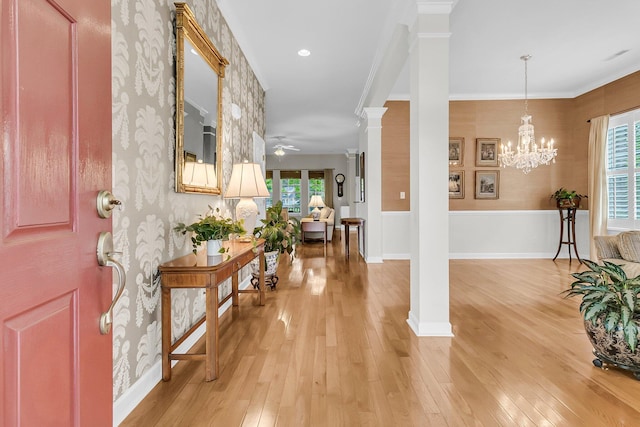 1809 Two Cedar Way, Mount Pleasant, SC 29466 - foyer entrance featuring ceiling fan, ornate columns, light wood finished floors, crown molding, and wallpapered walls
