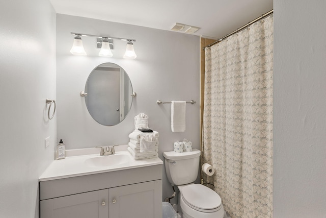 bathroom featuring curtained shower, vanity, and toilet