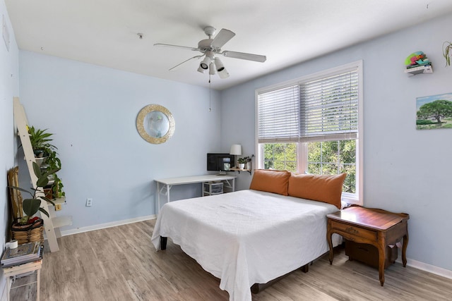 bedroom with baseboards, a ceiling fan, and light wood finished floors
