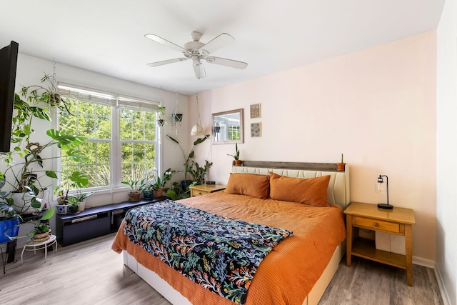 bedroom with baseboards, a ceiling fan, and wood finished floors
