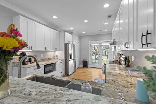 7 Wesley Dr, Charleston, SC 29407 - kitchen featuring stainless steel fridge with ice dispenser, french doors, light stone countertops, white cabinetry, and recessed lighting