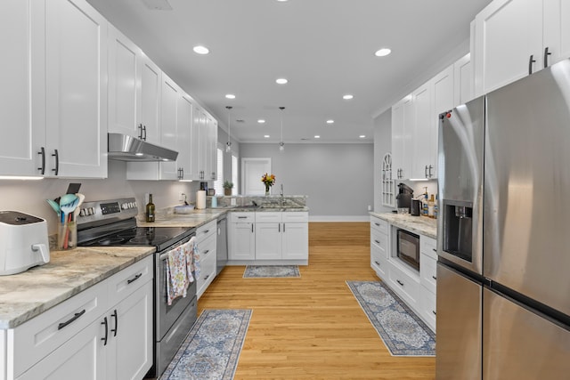 7 Wesley Dr, Charleston, SC 29407 - kitchen featuring stainless steel appliances, under cabinet range hood, a peninsula, light wood-style floors, and white cabinetry