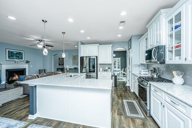 kitchen with ceiling fan, white cabinets, stainless steel appliances, and hanging light fixtures