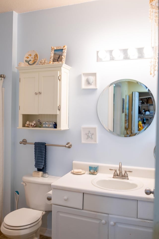 bathroom featuring vanity and toilet