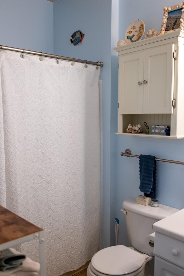 bathroom with vanity, toilet, and a shower with shower curtain