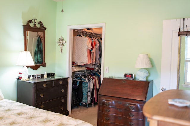 bedroom featuring carpet floors, multiple windows, a walk in closet, and a closet