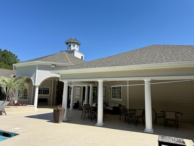 rear view of house featuring a shingled roof, an outdoor hangout area, a patio, and outdoor dining area