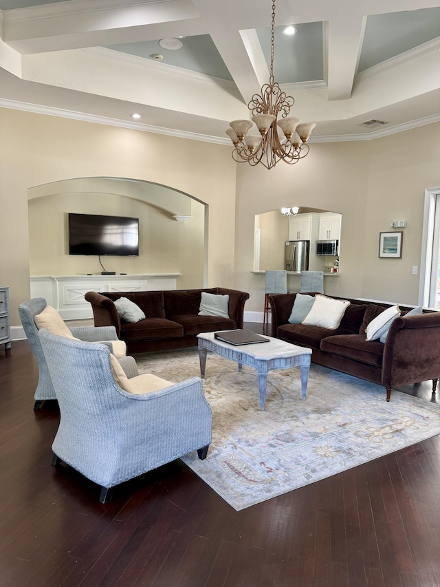 living room with crown molding, coffered ceiling, hardwood / wood-style floors, and a notable chandelier