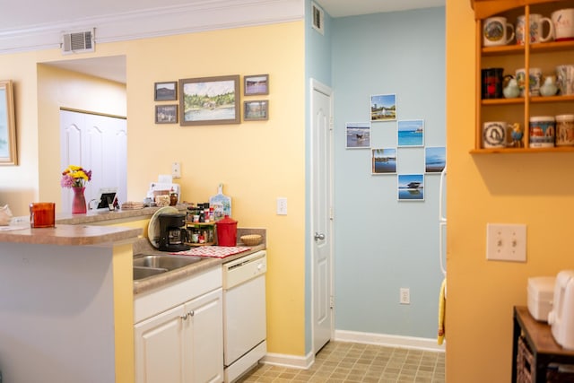kitchen featuring visible vents, baseboards, white dishwasher, light countertops, and white cabinets
