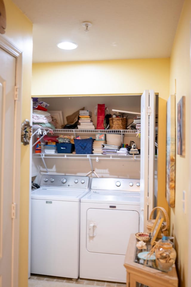 laundry room featuring washing machine and clothes dryer and laundry area