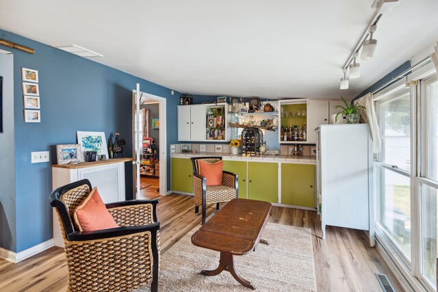 interior space with light hardwood / wood-style flooring and track lighting