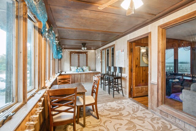 sunroom featuring wood ceiling and ceiling fan