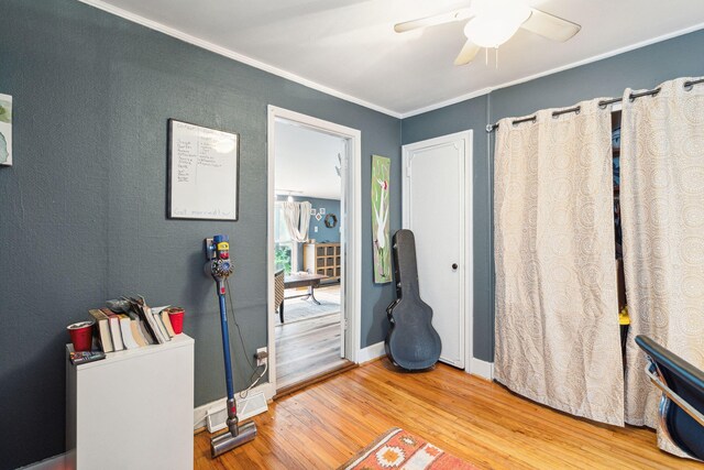 playroom with ornamental molding, hardwood / wood-style floors, and ceiling fan