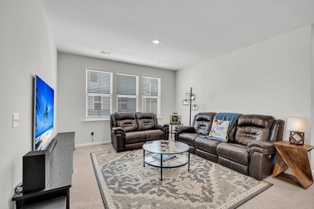 living room featuring baseboards, visible vents, and light colored carpet