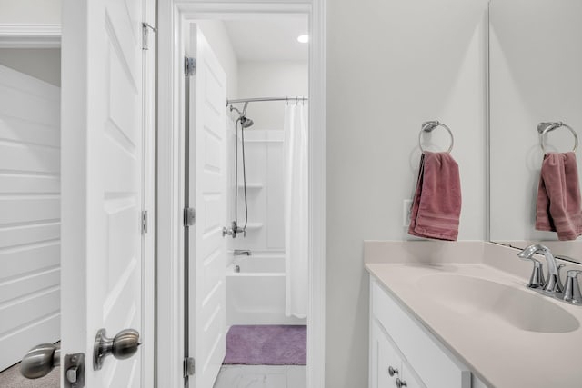 full bath featuring vanity, marble finish floor, and shower / bathtub combination with curtain