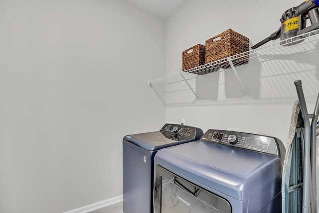 laundry area featuring laundry area, baseboards, and independent washer and dryer