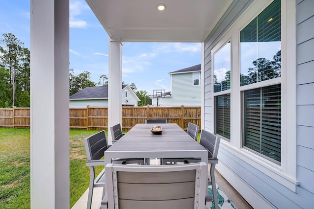 view of patio featuring fence and outdoor dining area