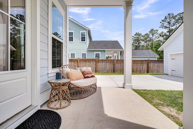 view of patio with fence and driveway