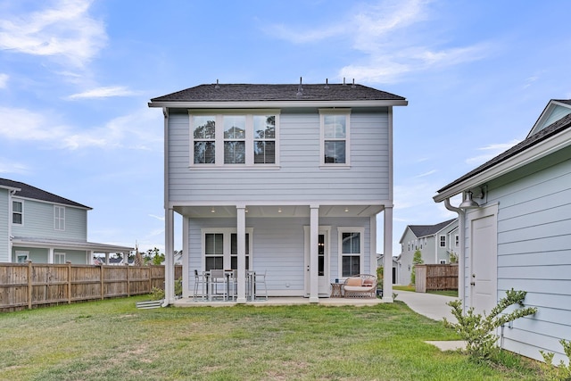 back of property featuring a patio area, fence, and a yard