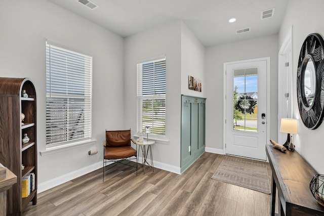 entrance foyer featuring visible vents, baseboards, and wood finished floors