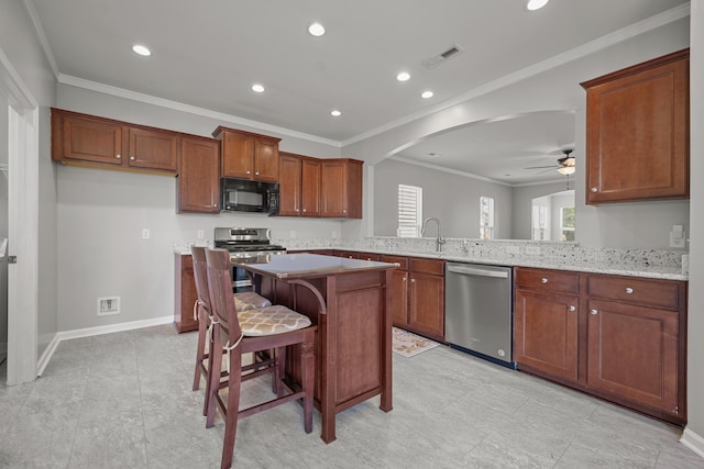 554 Tranquil Waters Way, Summerville, SC 29486 - kitchen with visible vents, arched walkways, a kitchen island, appliances with stainless steel finishes, and ceiling fan
