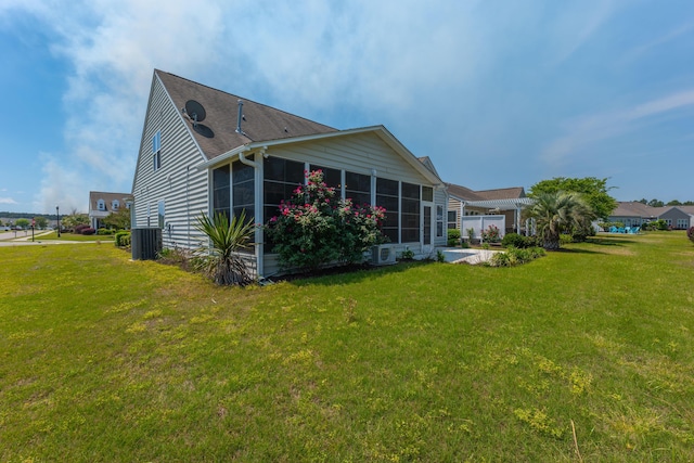 554 Tranquil Waters Way, Summerville, SC 29486 - back of property with a sunroom, a yard, roof with shingles, and central AC unit