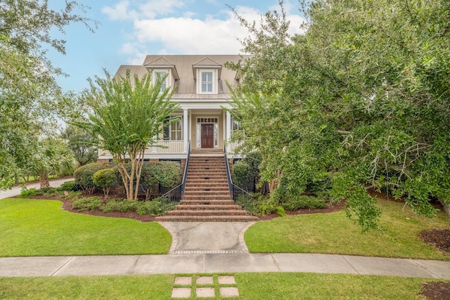 view of front of home with a porch and a front lawn