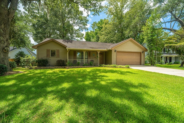 ranch-style house featuring covered porch, a garage, and a front lawn