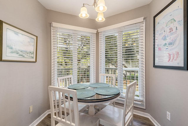 9000 Palmetto Dr Unit 202-C, Isle Of Palms, SC 29451 - dining area featuring a notable chandelier, baseboards, and wood finished floors