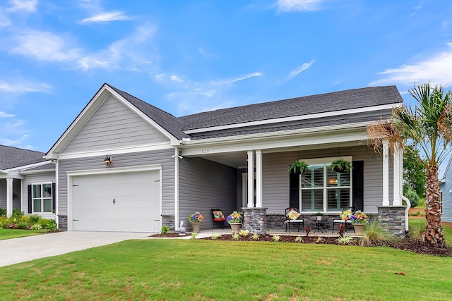 view of front of home with a front yard, a porch, and a garage