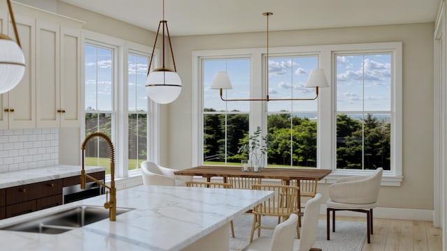 dining room with sink and light wood-type flooring