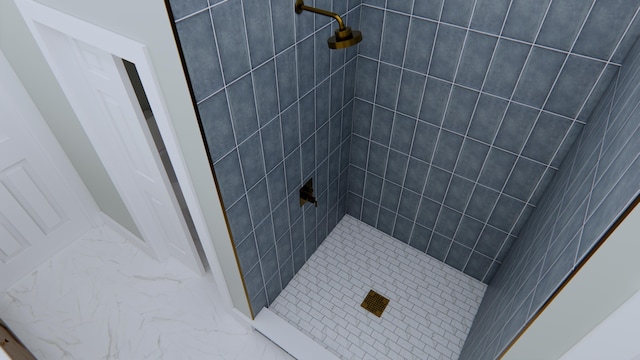 bathroom with a tile shower