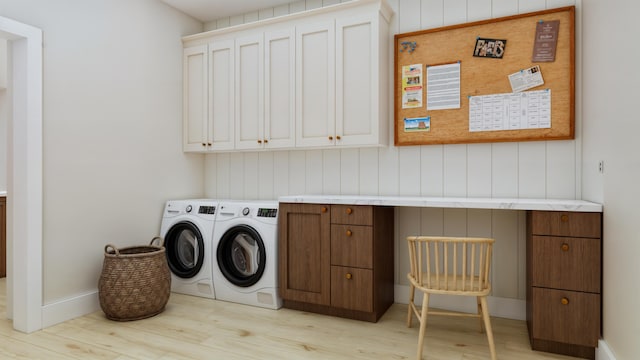 washroom with wooden walls, independent washer and dryer, light wood-type flooring, and cabinets