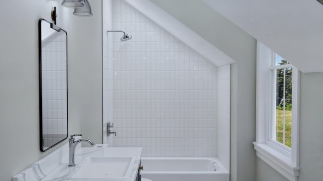 bathroom featuring vanity and tiled shower / bath combo