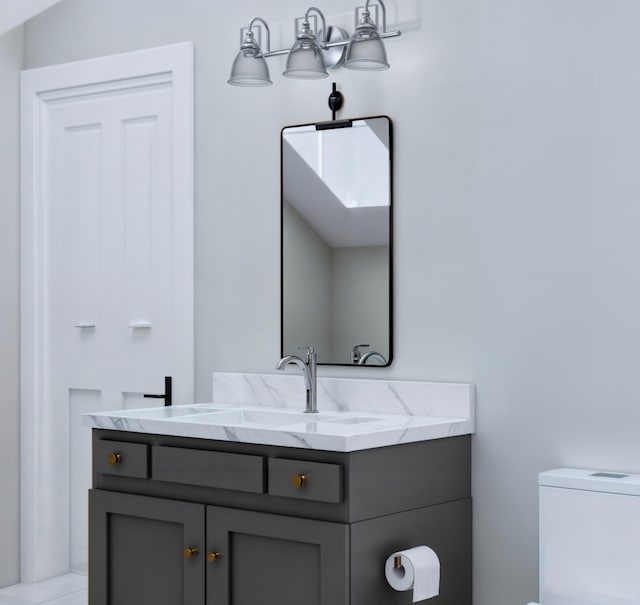 bathroom with vanity, vaulted ceiling, and toilet