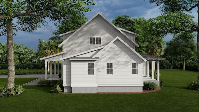 view of side of home with a yard and a patio