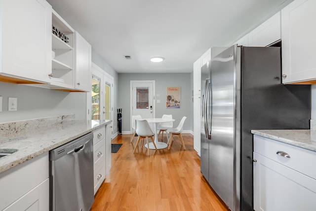 1821 Wasp St, North Charleston, SC 29405 - kitchen with open shelves, stainless steel appliances, white cabinetry, visible vents, and light wood-style floors
