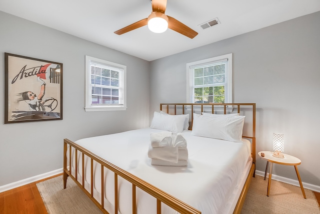 1821 Wasp St, North Charleston, SC 29405 - bedroom featuring wood finished floors, visible vents, baseboards, and ceiling fan