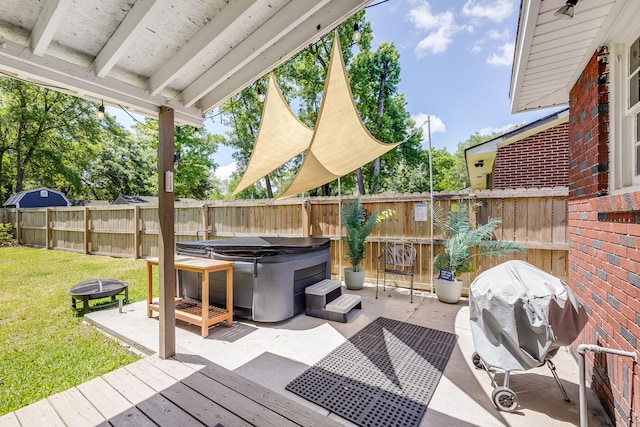 1821 Wasp St, North Charleston, SC 29405 - view of patio with a hot tub, area for grilling, a fenced backyard, a wooden deck, and an outdoor fire pit