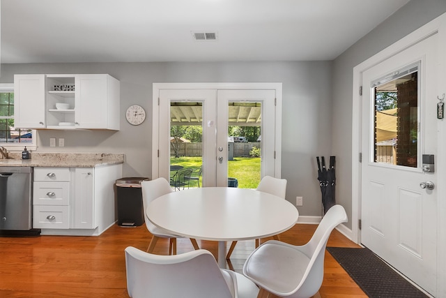1821 Wasp St, North Charleston, SC 29405 - dining space featuring a wealth of natural light, light wood finished floors, french doors, and visible vents