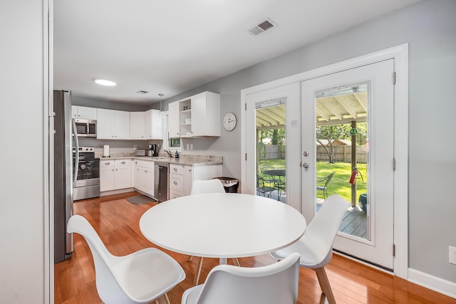 1821 Wasp St, North Charleston, SC 29405 - dining space featuring french doors, light wood-style flooring, and visible vents