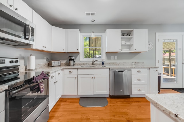 1821 Wasp St, North Charleston, SC 29405 - kitchen featuring visible vents, a sink, white cabinetry, light wood-style floors, and stainless steel appliances