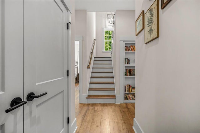 stairs with hardwood / wood-style flooring and baseboards